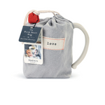Cream‑white ceramic Dema­­co Heart Mug in pouch with red heart outline and “Loving” sentiment, 12 oz capacity—perfect for coffee, tea, or hot cocoa. Available at Be Charmed