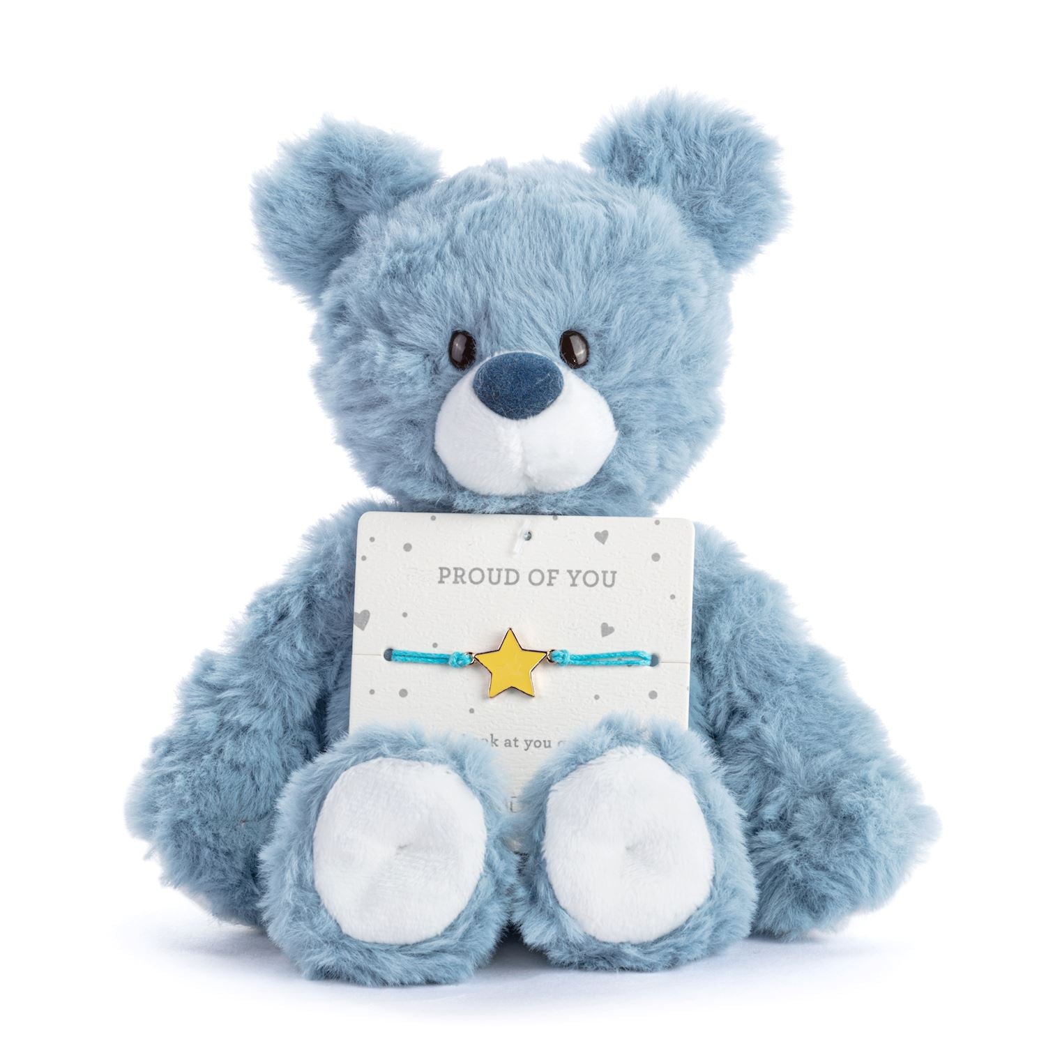 Blue teddy bear holding a 'Proud of You' card with a star bracelet on a white background. Available at Be Charmed