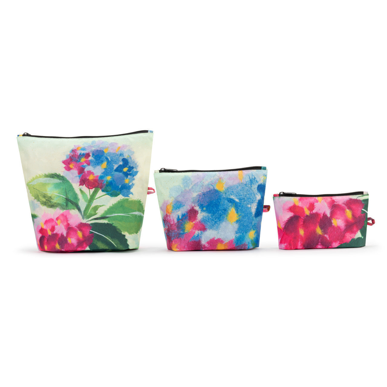 Demdaco ArtLifting pouch set featuring Hydrangea Ajisai artwork by Midori—three sizes (small, medium, large), water‑repellent polyester, zip closures. Available at Be Charmed.