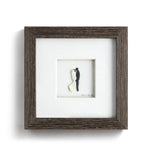 Demdaco “I Do” framed gray wall art by Sharon Nowlan, pebble art design depicting engagement scene—Available at Be Charmed.