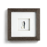 Demdaco “I Do” framed gray wall art by Sharon Nowlan, pebble art design depicting engagement scene—Available at Be Charmed.