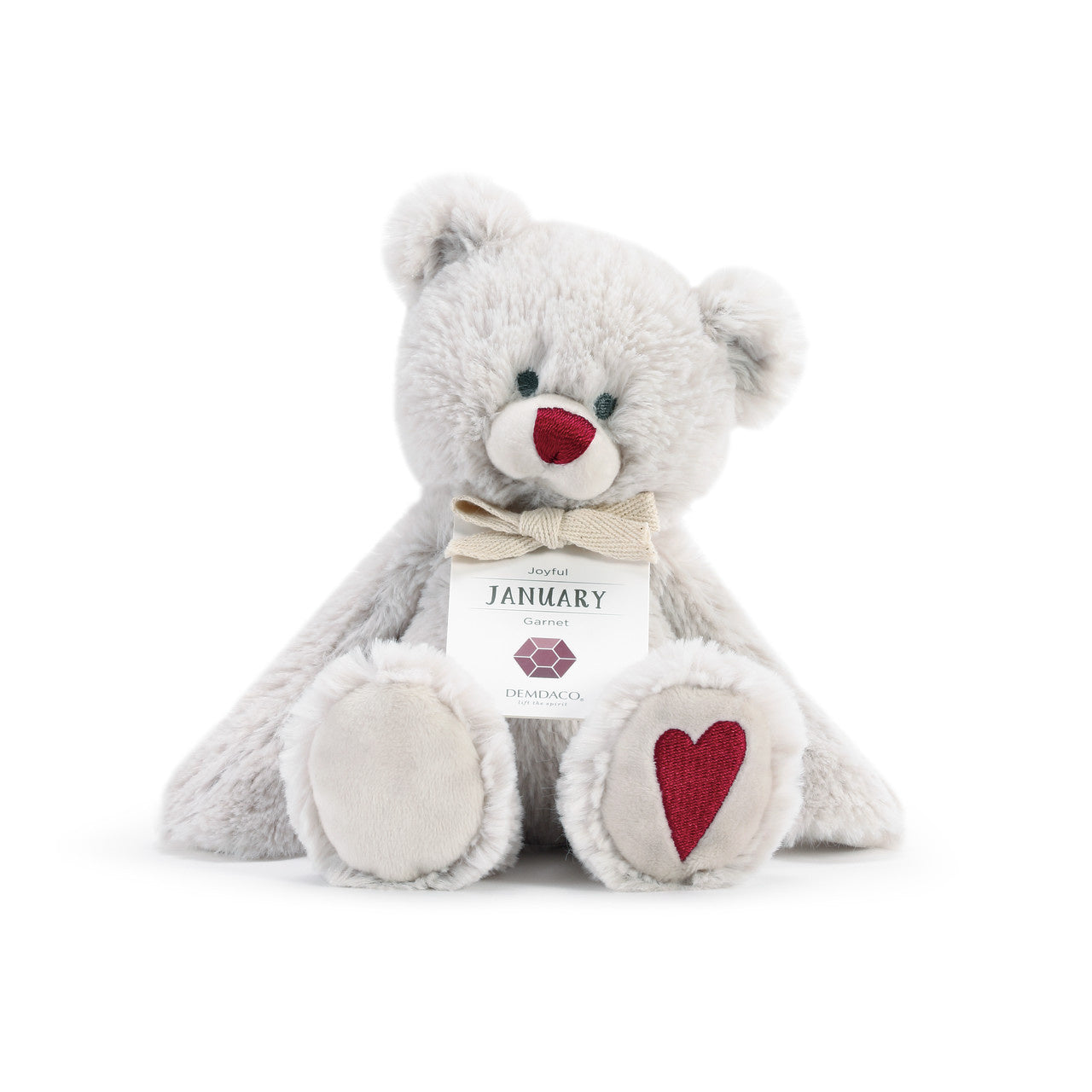 A plush teddy bear with a birthstone theme, featuring a ribbon around its neck that indicates the month of January. Available at Be Charmed