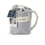 Demdaco “Kind” Heart Mug in pouch, 16 oz stoneware with heart cutout and “Kind” sentiment in warm ceramic—microwave & dishwasher safe—available at Be Charmed.