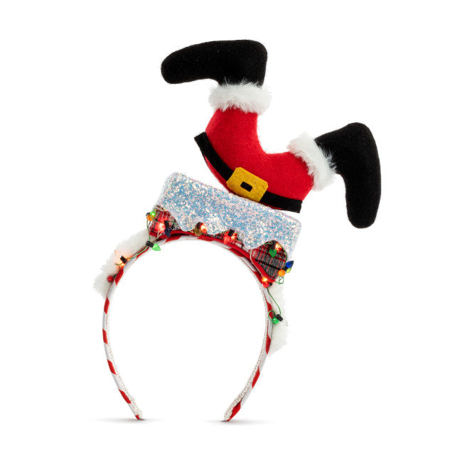 Demdaco Lit Santa Down Chimney Headband with LED lights, featuring Santa's legs dangling from a chimney—adds festive cheer. Available at Be Charmed.