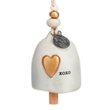 Ceramic Demdaco Love Mini Inspired Bell (~2″×2.5″) with hanging cord and wood bead—uplifting decor with inspirational message. Available at Be Charmed.