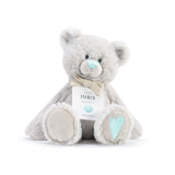 A plush teddy bear with a birthstone theme, featuring a ribbon around its neck that indicates the month of March. Available at Be Charmed