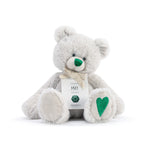 A plush teddy bear with a birthstone theme, featuring a ribbon around its neck that indicates the month of May. Available at Be Charmed