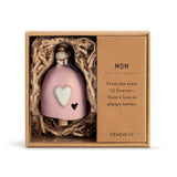 Ceramic Demdaco Mom Mini Inspired Bell (~2″×2.5″) pictured in box; with hanging cord and wood bead—uplifting decor with inspirational message. Available at Be Charmed.