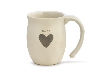 A beige ceramic mug with a heart shape and the word 'nana' printed on the side. Availabe at Be Charmed