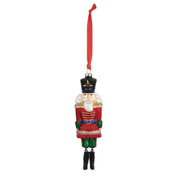 Demdaco blown glass Nutcracker ornament, 7.5″ tall with glitter, resin details & ribbon hanger—traditional holiday heirloom. Available at Be Charmed.