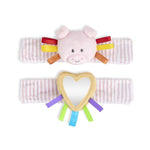Demdaco Pig Wrist Rattle, 6″ polyester baby toy with soft textures, bright colors, comforting rattle, adjustable hook-and-loop strap—available at Be Charmed.