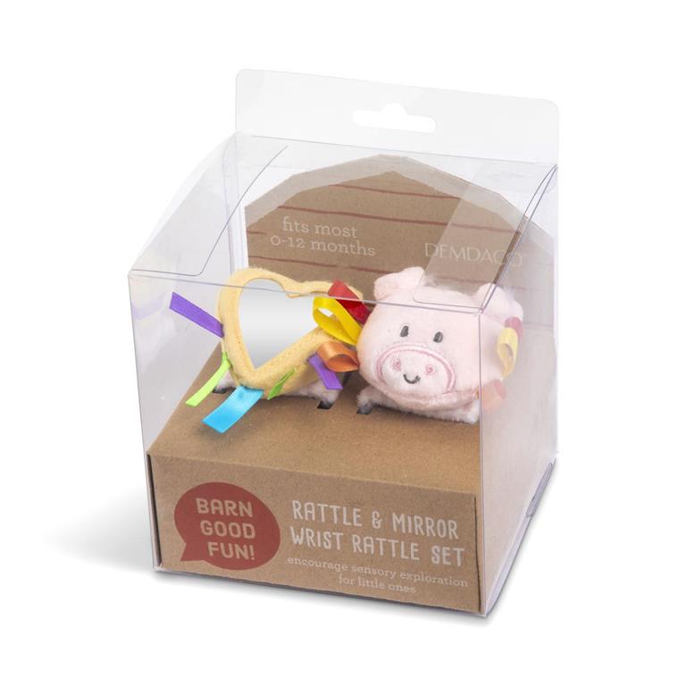Pictured in box; Demdaco Pig Wrist Rattle, 6″ polyester baby toy with soft textures, bright colors, comforting rattle, adjustable hook-and-loop strap—available at Be Charmed.
