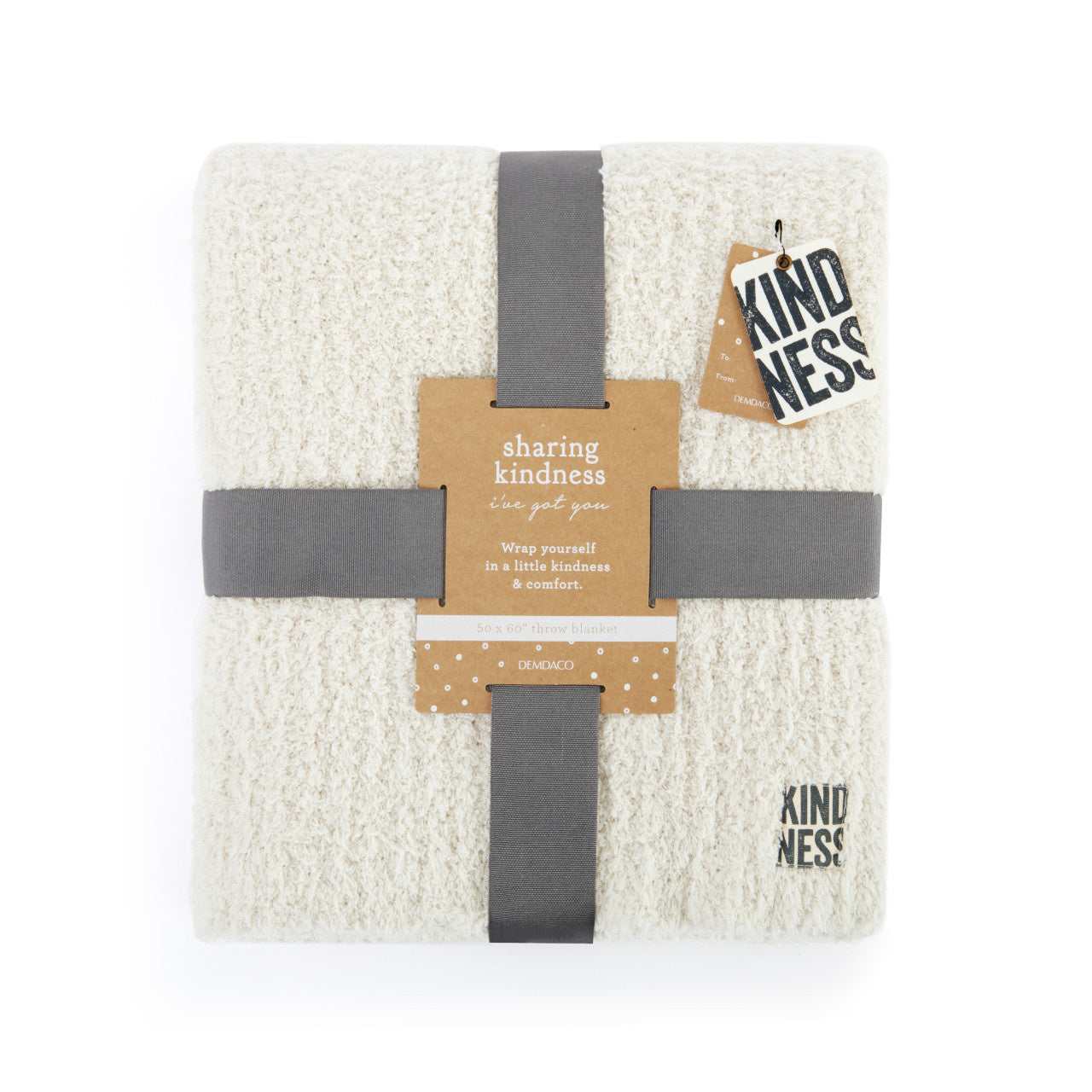 Demdaco Kindness Sand throw blanket, 50″×60″ soft polyester with subtle stitched “Kindness” tag in corner—Available at Be Charmed.