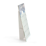 Side view of standing Demdaco Scratch-Off Advent Calendar with festive holiday design featuring 25 numbered scratch-off sections for daily surprises. Interactive and fun for families. Available at Be Charmed