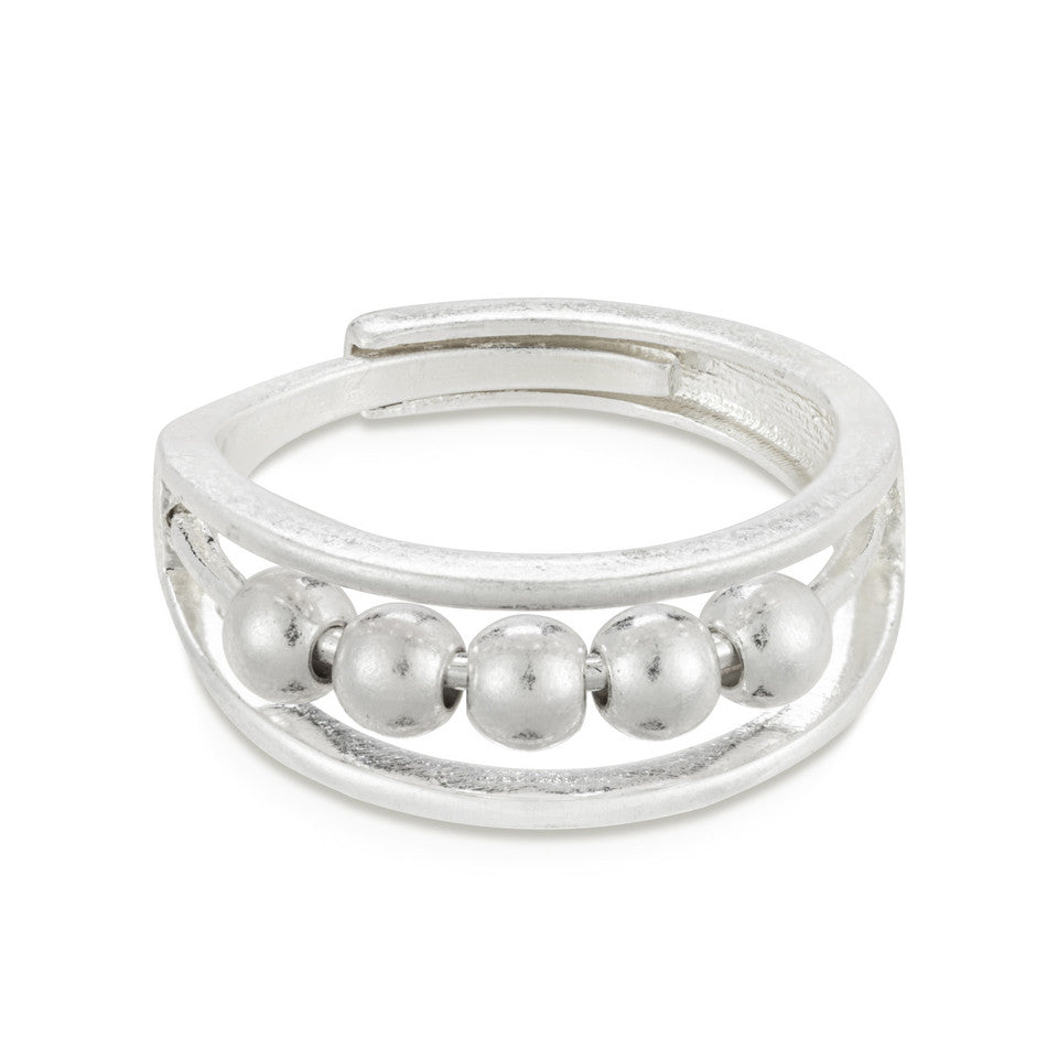A silver-colored ring with multiple small spherical embellishments around the band, designed to be adjustable by pinching at the back.  Available at Be Charmed