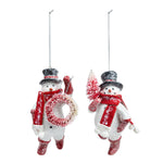 Demdaco hand‑painted “Sparkly Snowmen” glass ornament with silver glitter accents and red ribbon hanger—festive holiday décor. Available at Be Charmed.