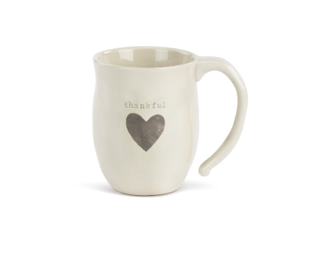 Demdaco Thankful heart-shaped stoneware mug, 16 oz capacity, hand‑thrown feel with raised heart—available at Be Charmed.
