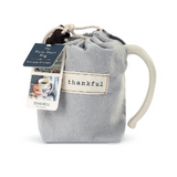 Demdaco Thankful Heart Mug in cream stoneware with a heart design in fabric pouch, available at Be Charmed.