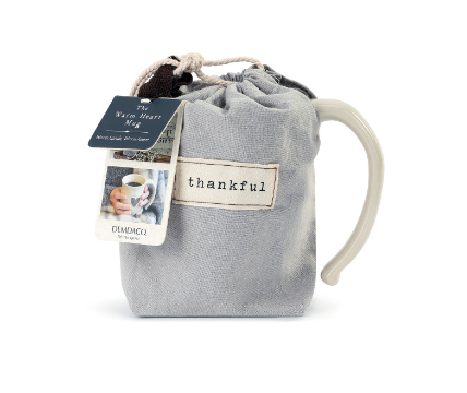 Demdaco Thankful Heart Mug in cream stoneware with a heart design in fabric pouch, available at Be Charmed.