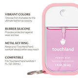 Pink hand sanitizer with key ring and case, featuring Touchland branding. Available at Be Charmed
