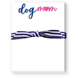 A notepad featuring the text 'dog mom' in blue and pink, and secured with a blue and white striped ribbon. Available at BE Charmed