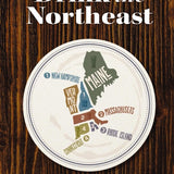 Book cover of 'Drink the Northeast' featuring a circular graphic with text and state names, indicating a guide to wineries, breweries, and distilleries in the Northeast region of the USA. Available at Be Charmed
