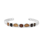 Silver cuff bracelet with embedded stones on a white background. Available at Be Charmed