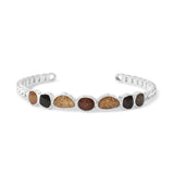 Silver cuff bracelet with embedded stones on a white background. Available at Be Charmed