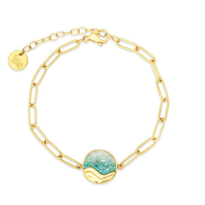 Gold chain bracelet with a turquoise stone on a white background. Available at Be Charmed