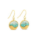 Gold earrings with turquoise stones on a white background. Available at Be Charmed