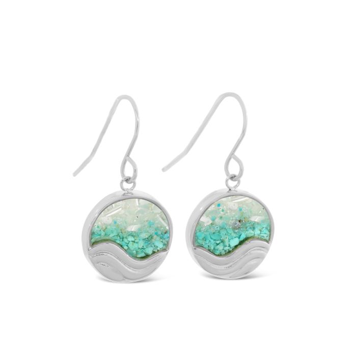 Pair of silver earrings with turquoise and white design on a white background. Available at Be Charmed