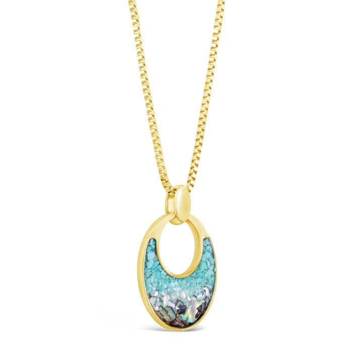 Gold necklace with a turquoise pendant on a white background. Available at Be Charmed