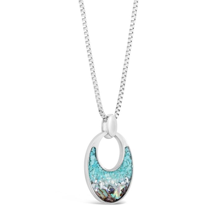 Silver necklace with a turquoise pendant on a white background. Available at Be Charmed