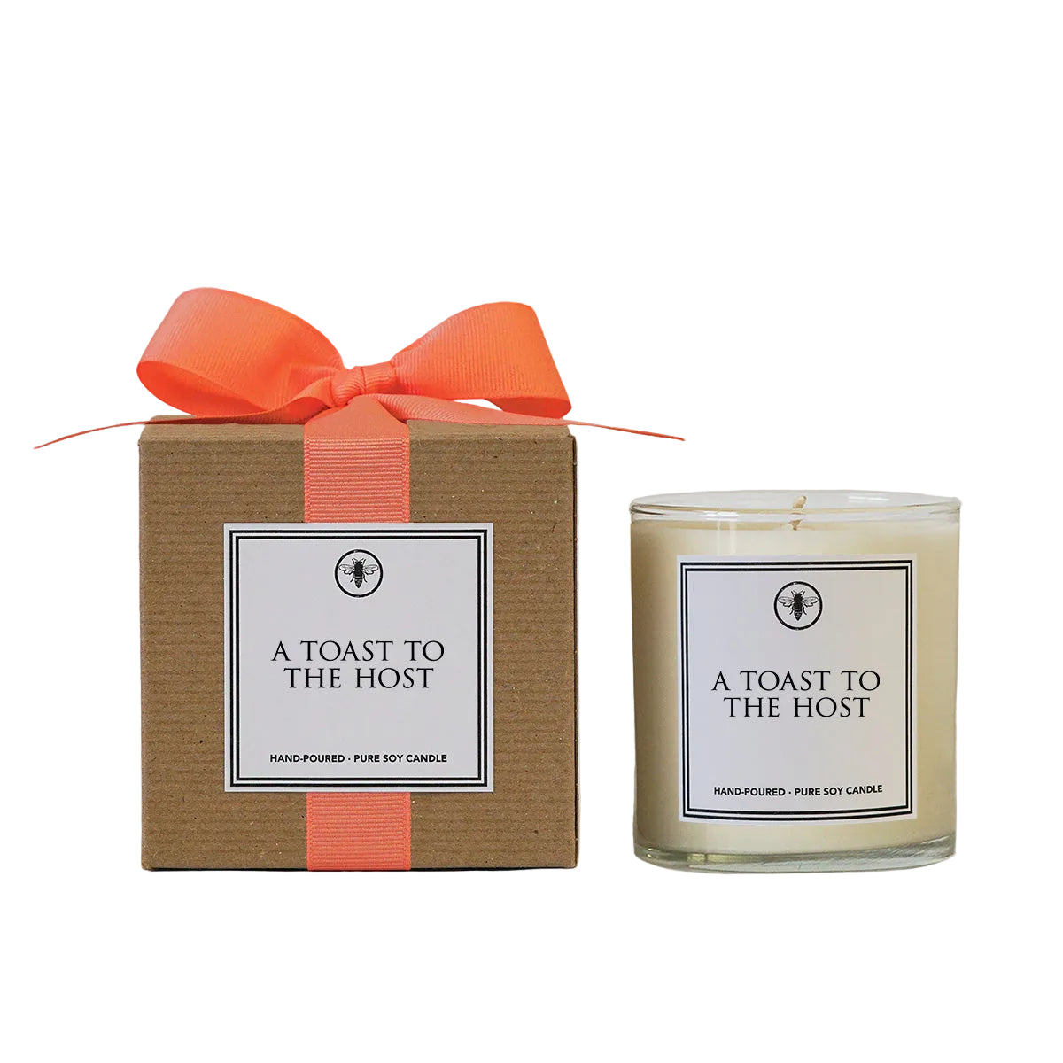 Candle labeled 'A Toast to the Host' with a matching box and orange ribbon on a light gray background. Available at Be Charmed