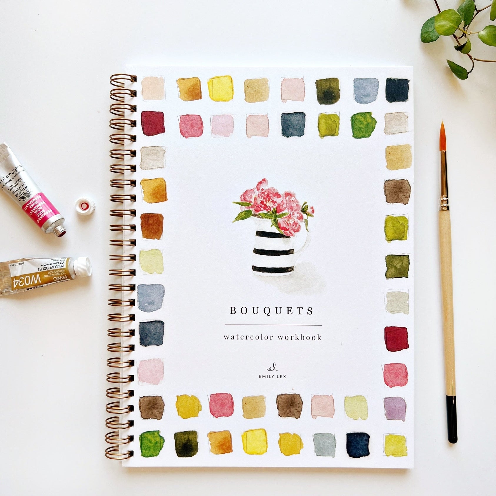 Watercolor workbook titled 'Bouquets' with color swatches and art supplies on a white background. Available at Be Charmed