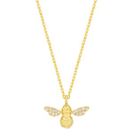 Gold bee pendant necklace on a white background. Available at Be Charmed