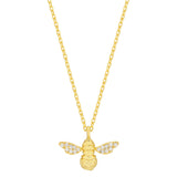 Gold bee pendant necklace on a white background. Available at Be Charmed