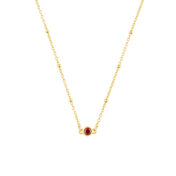 January FYB Gold Birthstone Necklace featuring a dainty bezel-set stone on a delicate gold chain. Available at Be Charmed