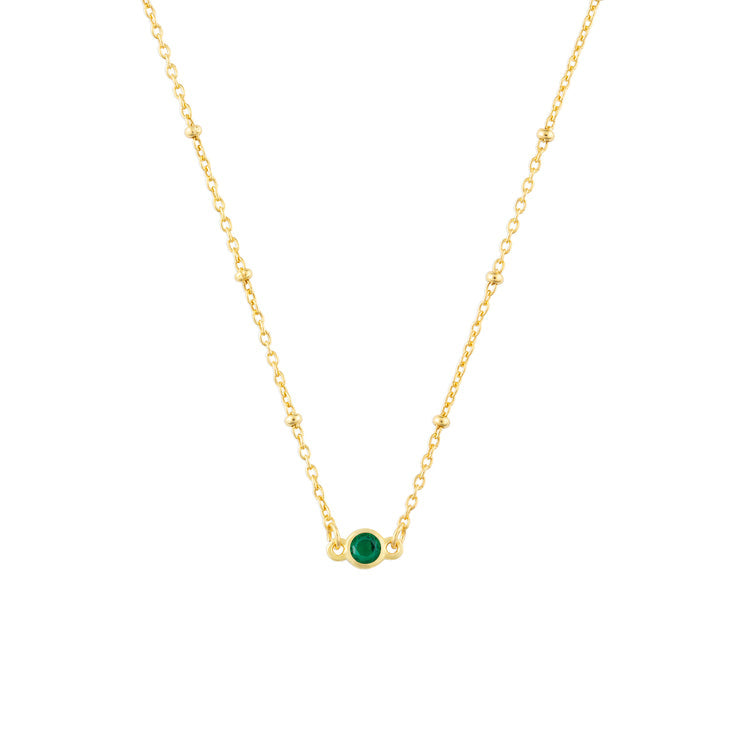 May FYB Gold Birthstone Necklace featuring a dainty bezel-set stone on a delicate gold chain. Available at Be Charmed.