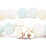 Fahlo Sky Stone beaded bracelet with a white lion figure as the central charm. Available at Be Charmed
