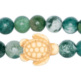 Beaded bracelet with a turtle charm on a white background. Available at Be Charmed