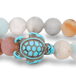 A Fahlo Sky Stone bracelet featuring a turtle charm in the center. Available at Be Charmed