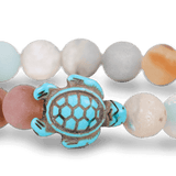 A Fahlo Sky Stone bracelet featuring a turtle charm in the center. Available at Be Charmed
