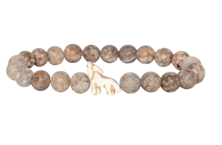 A beaded stretch Fahlo bracelet made of round, mottled brown and beige stone beads, featuring a small white carved wolf charm in the center, shown on a plain white background. Available at Be Charmed