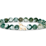 A beaded stretch Fahlo bracelet featuring round green and white marbled beads with a small white wolf charm outlined in gold, displayed on a clean white background. Available at Be Charmed