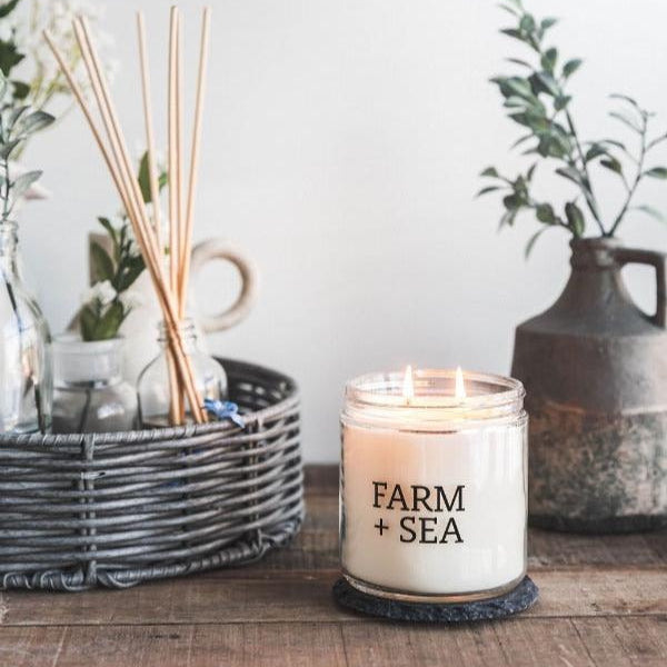 Farm + Sea Beach Girl 14 oz scented candle with fresh coastal scent and natural ingredients. Clean-burning and long-lasting. Available at Be Charmed.
