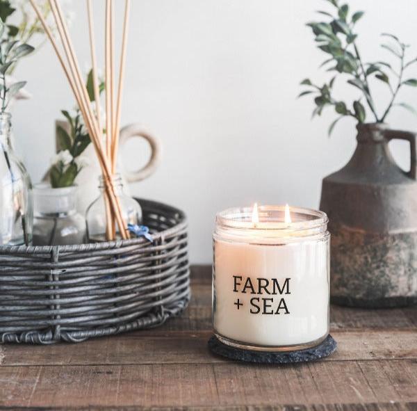 Farm + Sea Salt Air 14 oz scented candle with fresh coastal ocean scent and natural ingredients. Clean-burning and long-lasting. Available at Be Charmed.
