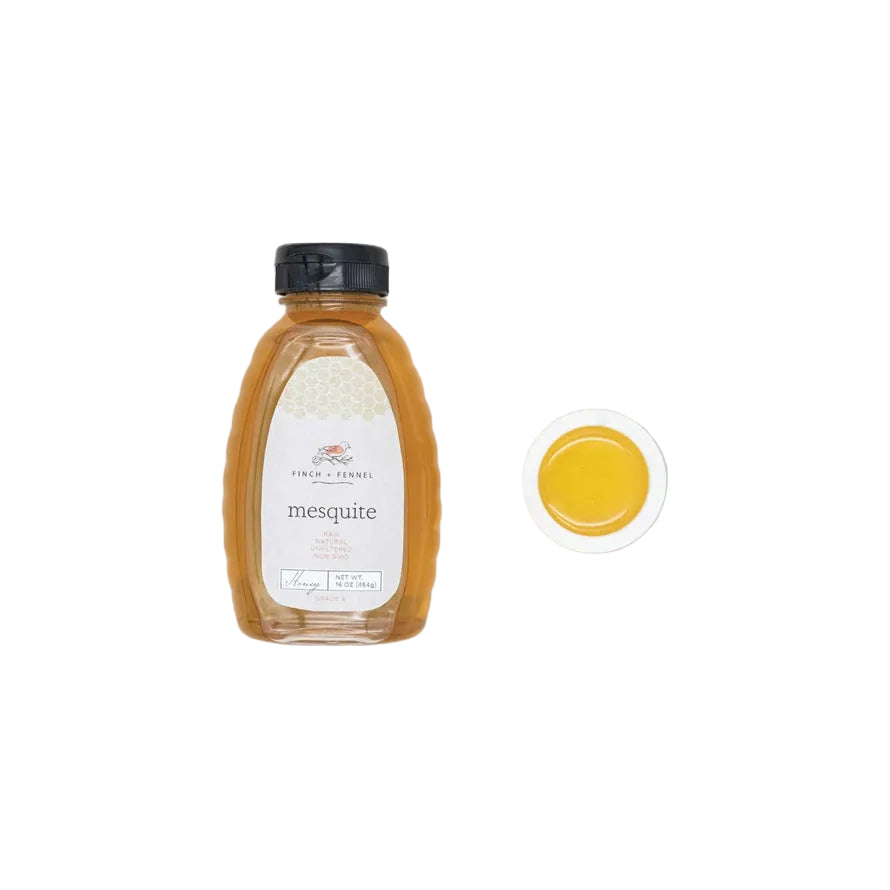 Bottle of mesquite honey with a close-up of honey on a white background. Available at Be Charmed
