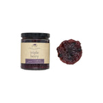 Jar of triple berry preserve with a single berry on a white background. Available at Be Charmed
