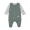 Green baby romper with sleeves with airplanes and hot balloons on them on a white background. Available at Be Charmed.